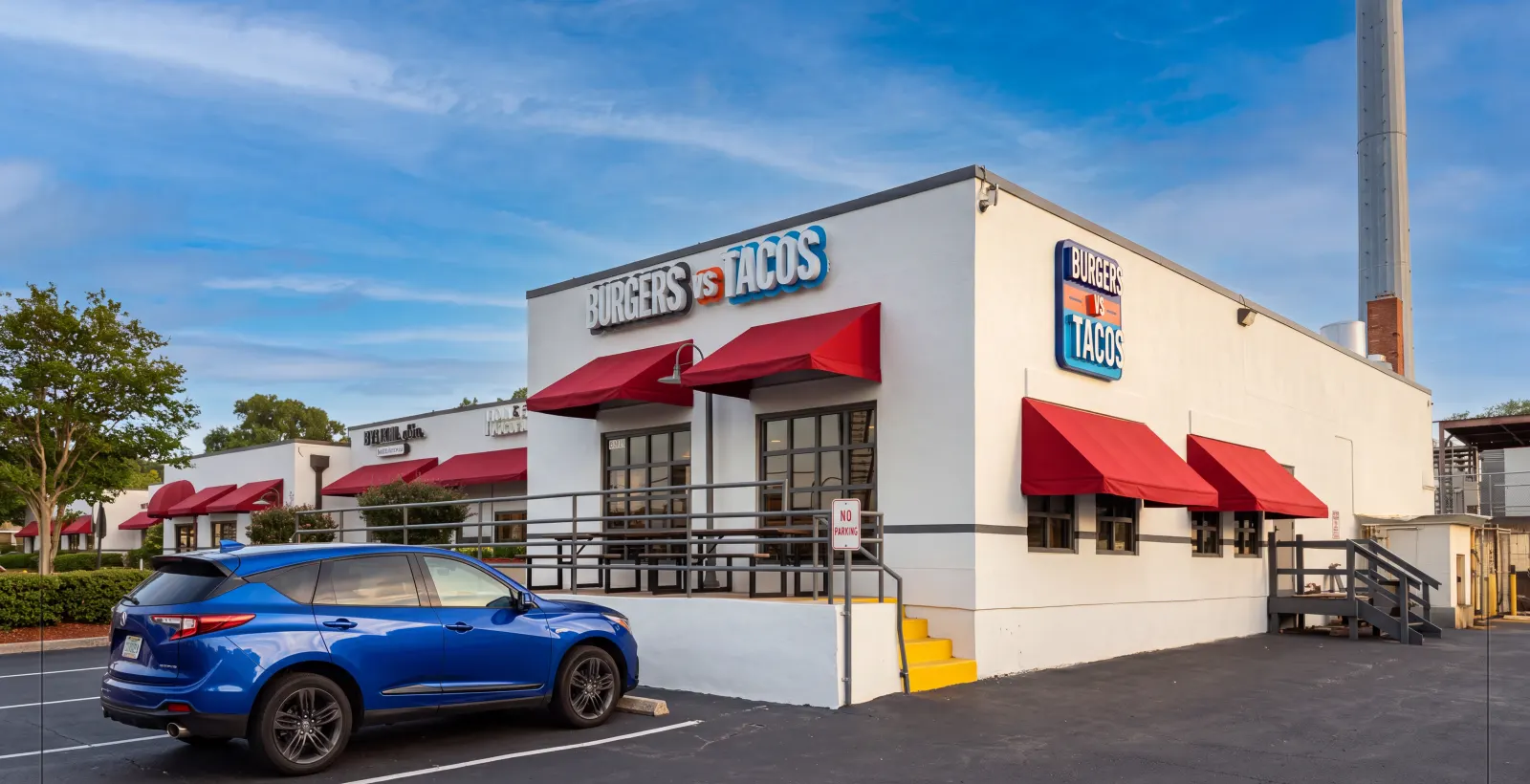 Wide view of the spot with a full parking lot out front