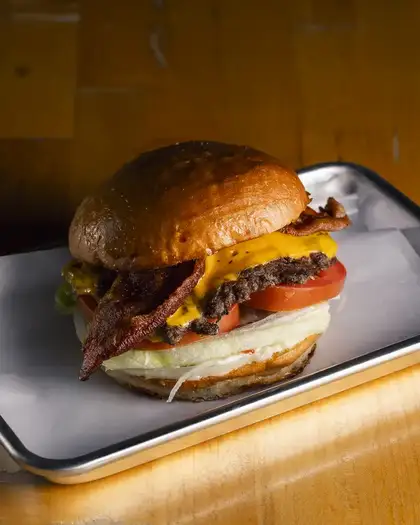 Freshly built smash burger with bacon and melted cheese