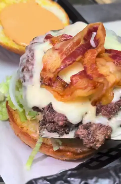 Crispy bacon and melted cheese over a double patty