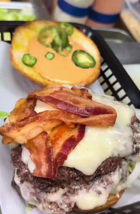 Freshly built smash burger with bacon and melted cheese