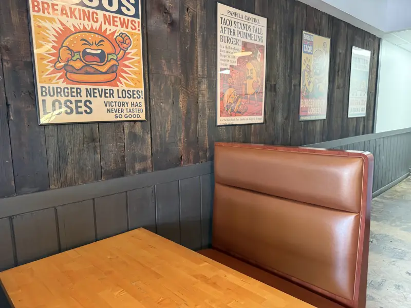 Brown leather booth with a wood table